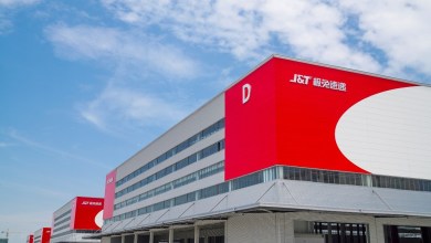 Red-and-white facade of a J&T Express warehouse.
