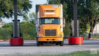 a Yellow tractor at a truckstop