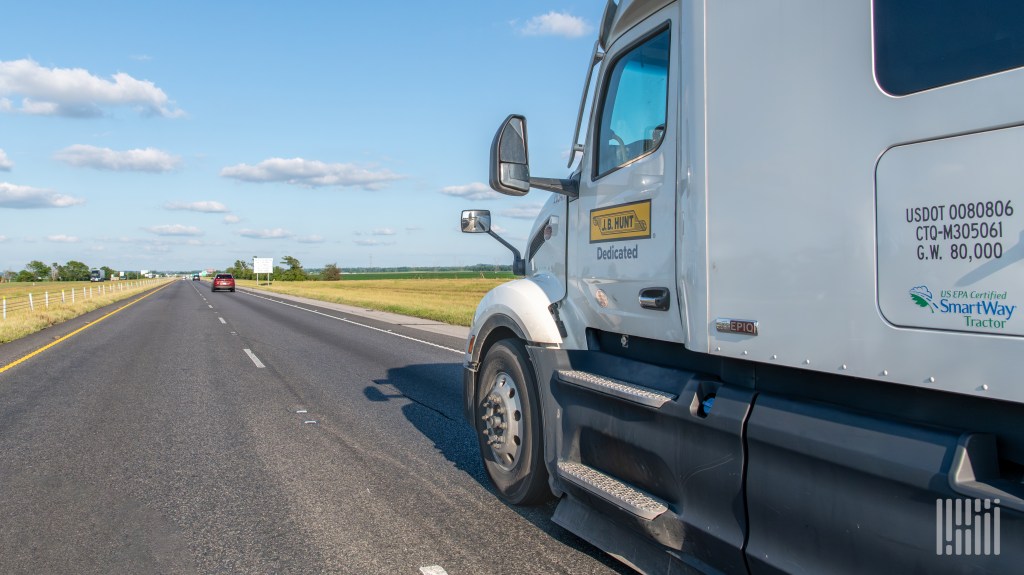 A white JB Hunt dedicated tractor on a highway