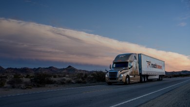 A gold Roadrunner sleeper cab pulling a white Roadrunner trailer