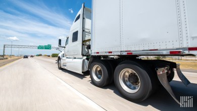 a white sleeper cab with a white trailer
