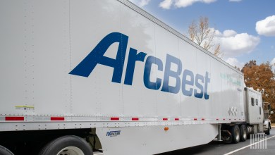 A closeup of a white ArcBest trailer in a parking lot