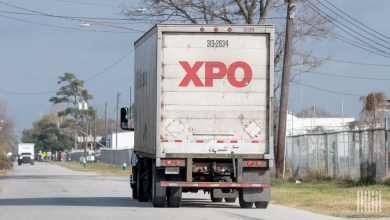 A photo of an XPO straight truck on a side road