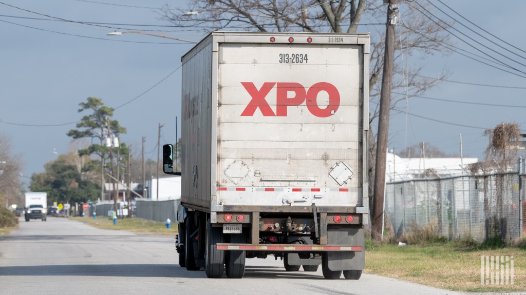 A photo of an XPO straight truck on a side road