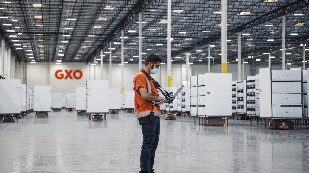 An employee working on a GXO warehouse floor