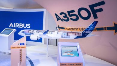 A scale model of an Airbus A350 freighter at an air show exhibit hall.