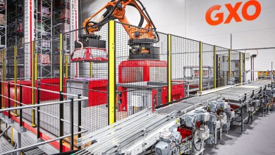 a robot arm and a conveyor belt at a GXO facility