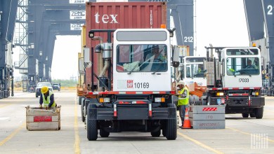 spotter trucks moving containers at a port