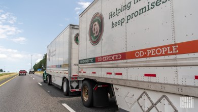 A closeup of two Old Dominion pup trailers being pulled on a highway