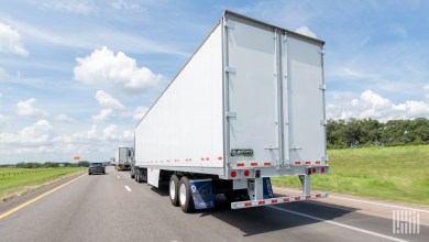 a white trailer being pulled on a highway