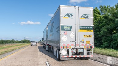 A rear view of two ABF Freight trailers being pulled on a highway