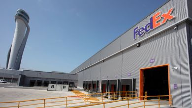 A FedEx air parcel warehouse at Istanbul airport, with control tower in the background.