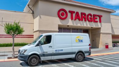 An OnTrac delivery van is parked in front of a Target store.