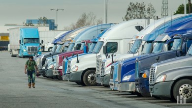 truck driver walking among parked trucks
