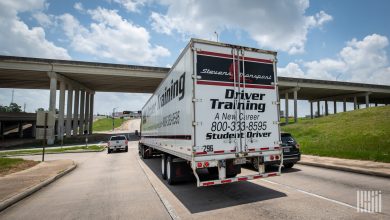 An image of a tractor trailer with driver training wrote on the back doors. The truck driver appears to be a student driver, similiar to what ATRI plans to study.