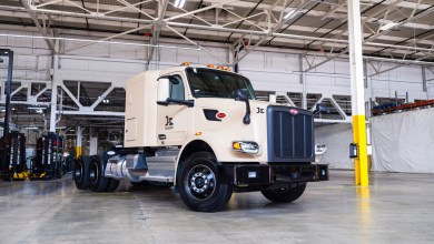 Kodiak Robotics' first factory-built autonomous truck, a beige Peterbilt semi-tractor, parked in Roush Industries' manufacturing facility in Livonia, Michigan.
