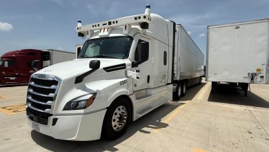 Bot Auto's white Freightliner autonomous semi-truck, model G003, with roof-mounted sensors and no driver, parked in a Houston lot during its first driverless hub-to-hub validation run.