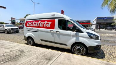 A red-and-white Estafeta delivery van on a street in Mexico.