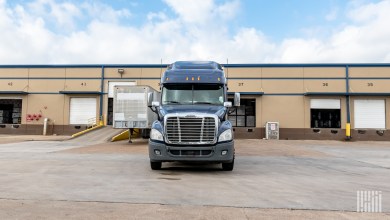 A blue tractor at a loading dock