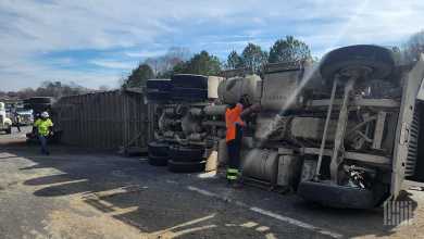 An image of a semi truck turned onto its side on the road, highlighting the need for additional FMCSA rulemaking to limit crashes