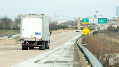 A white delivery truck on a highway