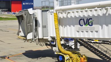 An empty passenger jetway with the CVG airport logo on the side.