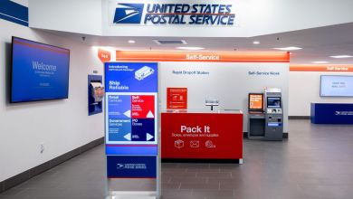 Blue-and-white post office lobby with self-service kiosks.