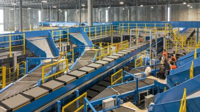 Inside of a parcel sorting terminal with large conveyor belts crisscrossing.