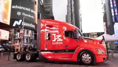 A red Kodiak autonomous semi-truck parked in Times Square, New York, in front of the Nasdaq building billboard during the company's public debut on the stock exchange.
