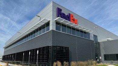 Close up of a FedEx cargo terminal with purple and orange lettering.