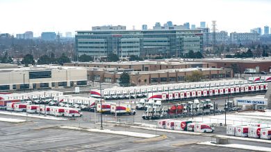 Aerial view of a large truck yard with Canada Post vehicles.