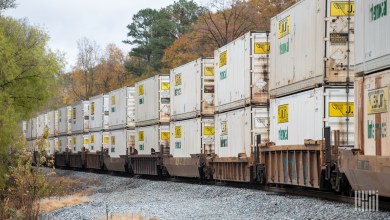 Numerous JB Hunt intermodal containers on well cars