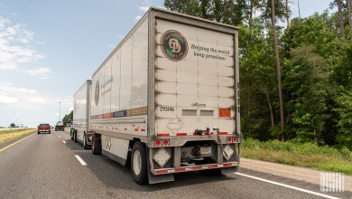 A rearview of Old Dominion pup trailers being pulled on a highway