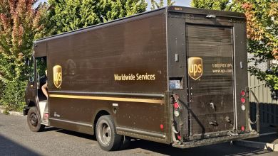 Rear side view of a brown UPS package car.