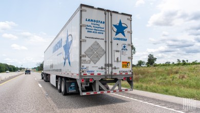 a rearview of a Landstar trailer on a highway