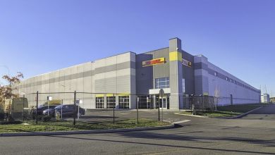 A large warehouse with the yellow-and-red DHL logo.