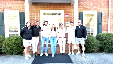 Scout Freight founding team and employees standing together outside a brick office building in Dalton, Georgia, wearing company-branded apparel.