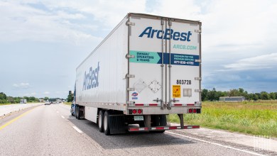 A rearview of an ArcBest trailer on a highway