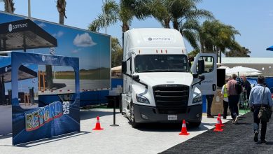 A Samsara-branded semi-truck and exhibit booth at the Beyond 2025 event, illustrating how AI-powered solutions address supply chain peak season challenges like extreme weather, labor shortages, and cargo theft, transforming them into opportunities for enhanced safety, efficiency, and workforce agility in logistics operations.