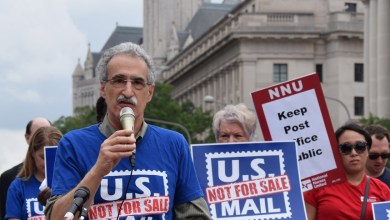Marchers in Washington, D.C. with signs saying U.S. Mail not for Sale.