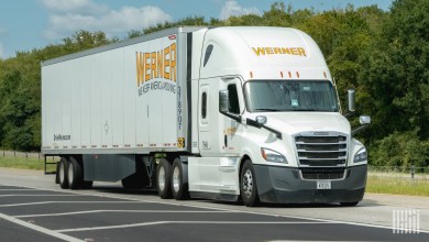 a white Werner sleeper cab pulling a white Werner dryvan trailer on a highway