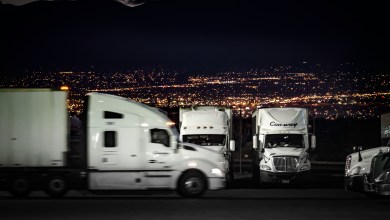 trucks in parking lot at night.