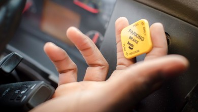 truck driver's hand on parking brake