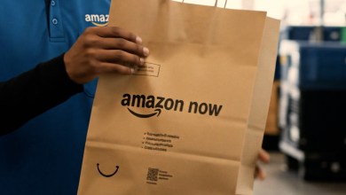 A close up of a paper bag with Amazon Now written on it and held by hand.
