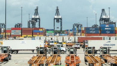 containers and trucks moving at a port