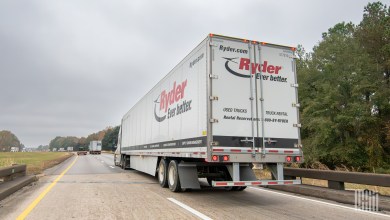 a Ryder trailer being pulled on a highway