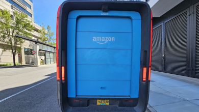 Closeup rear view of a light blue Amazon Prime delivery van.