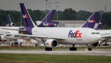 Purple-tailed FedEx planes at an airport.