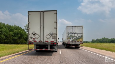 Rear view of two trucks on the highway.