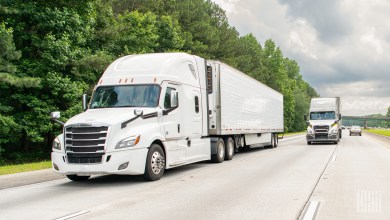 White tractor-trailers on a highway